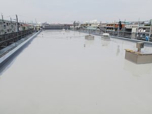 屋上防水作業中の様子です。こちらのマンションの防水仕上げはウレタン塗膜防水の通気緩衝工法が施工されておりました。濃いグレーの部分が通気シートです。この上にウレタン塗膜防水を塗り重ねるのですが、一部通気シートの下に水が浸入しシートの剥がれがございました。他所の通気シートは健全でしたので不良部分の通気シートを貼り替えてウレタン塗膜防水を施工しました。屋上防水作業中の様子です。こちらのマンションの防水仕上げはウレタン塗膜防水の通気緩衝工法が施工されておりました。濃いグレーの部分が通気シートです。この上にウレタン塗膜防水を塗り重ねるのですが、一部通気シートの下に水が浸入しシートの剥がれがございました。他所の通気シートは健全でしたので不良部分の通気シートを貼り替えてウレタン塗膜防水を施工しました。屋上防水作業中の様子です。こちらのマンションの防水仕上げはウレタン塗膜防水の通気緩衝工法が施工されておりました。濃いグレーの部分が通気シートです。この上にウレタン塗膜防水を塗り重ねるのですが、一部通気シートの下に水が浸入しシートの剥がれがございました。他所の通気シートは健全でしたので不良部分の通気シートを貼り替えてウレタン塗膜防水を施工しました。 こちらのマンションでは外壁にはしごが設置しており、それを利用して屋上に登ることができるのですが、足場がないとかなり危険です。